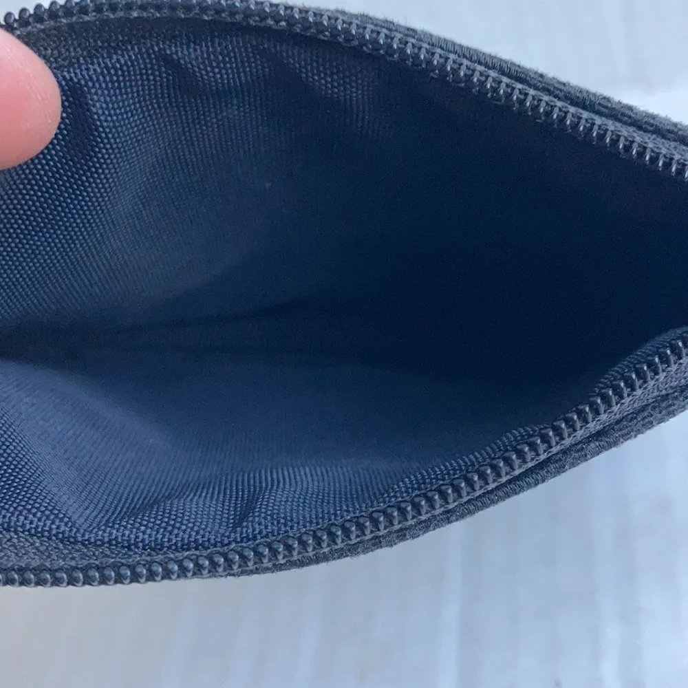 Coach black signature C mini wristlet.